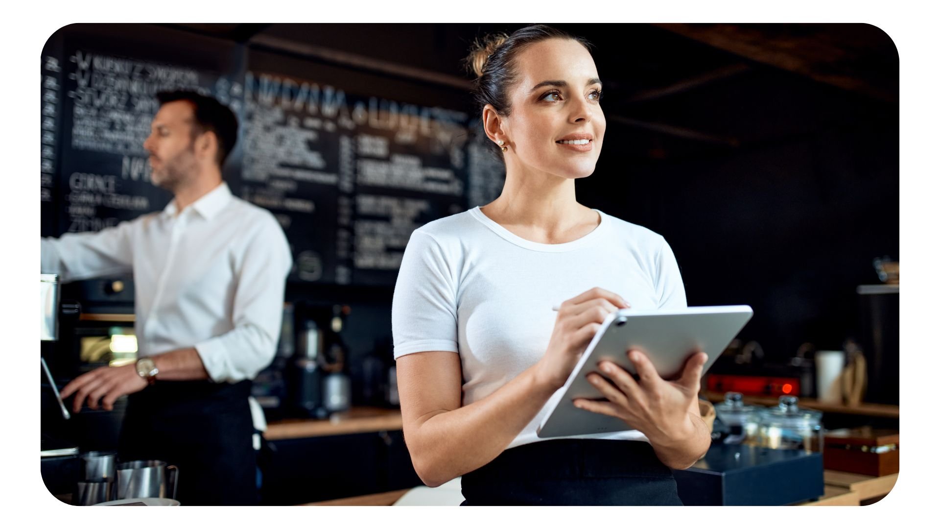 Woman working in restaurant on tablet device