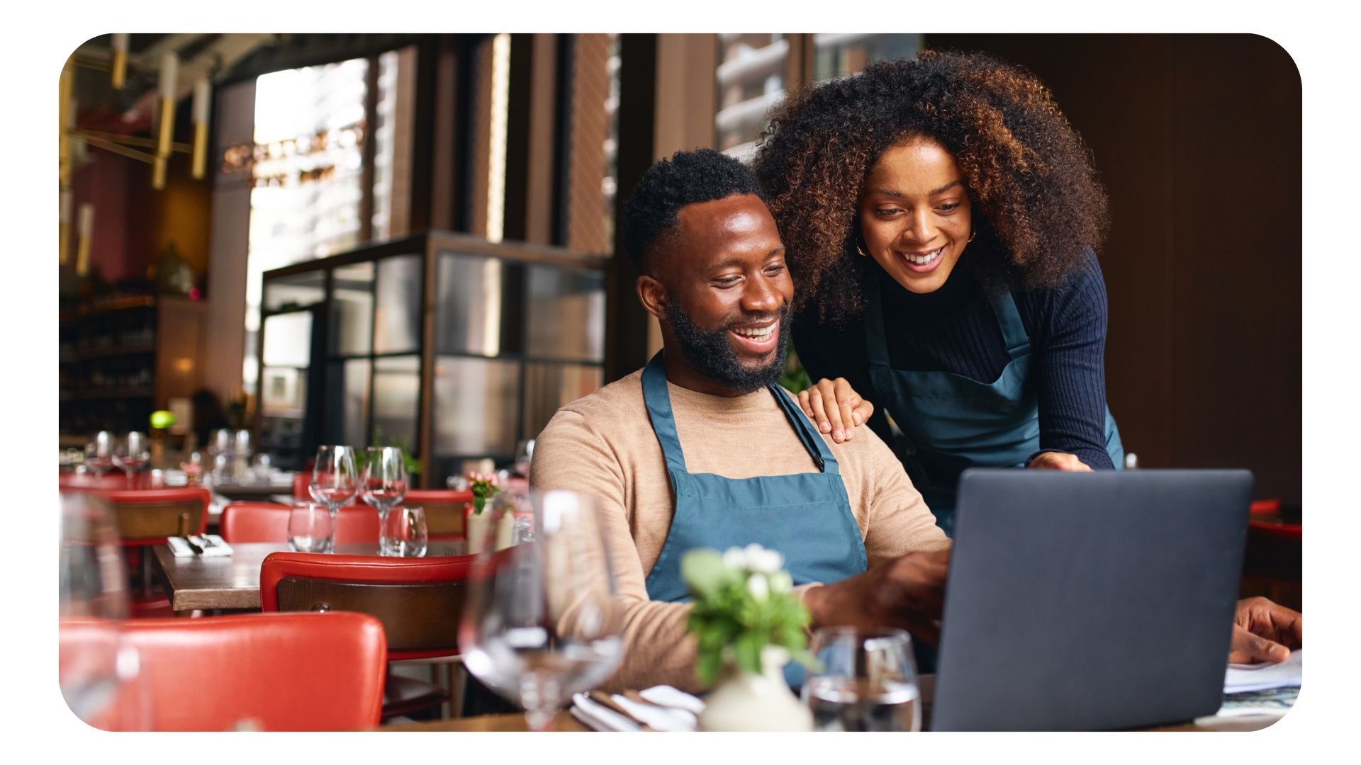 Photo of two restaurant managers working on laptop