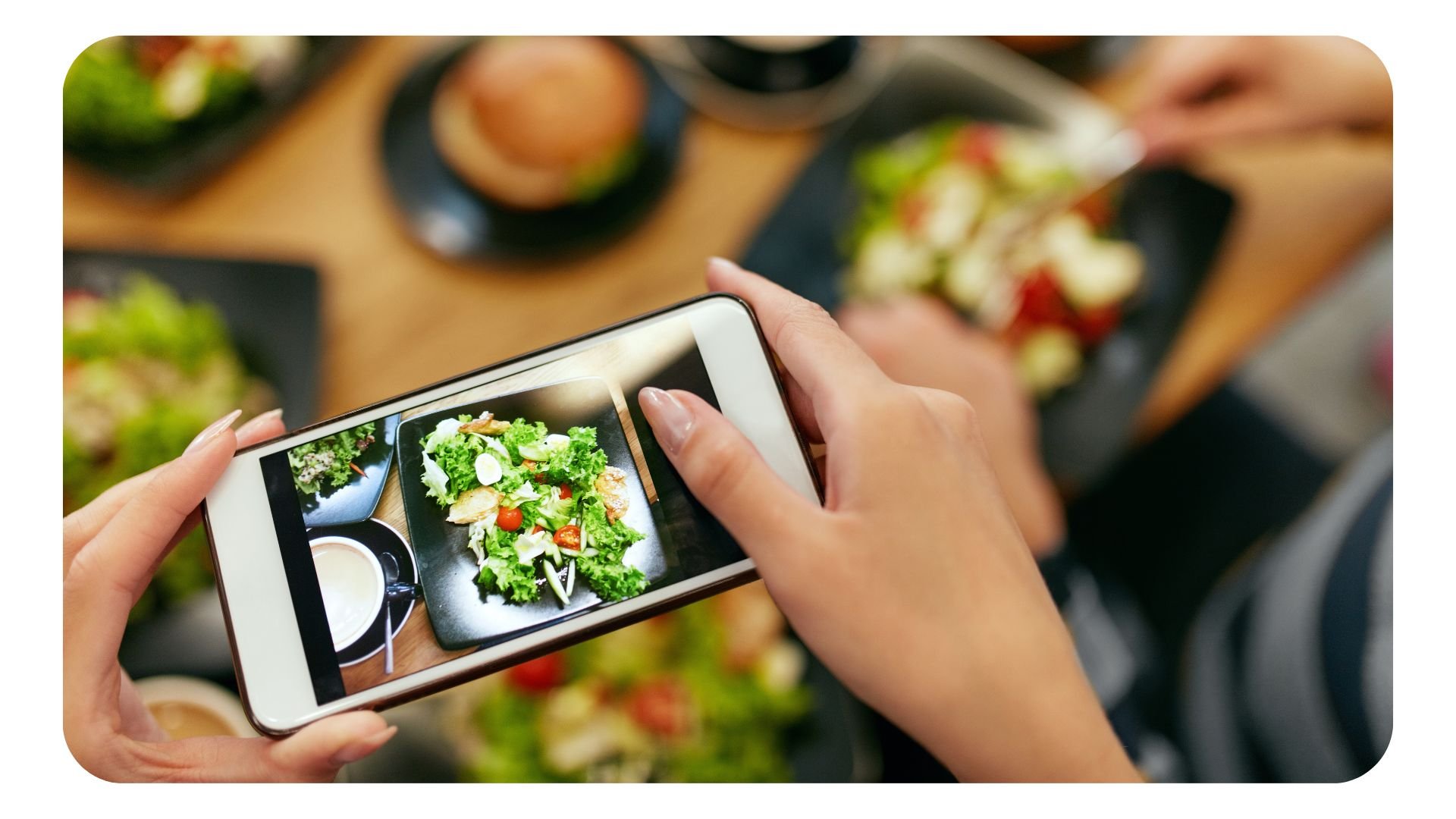 Woman using smartphone to take photo of food for social media