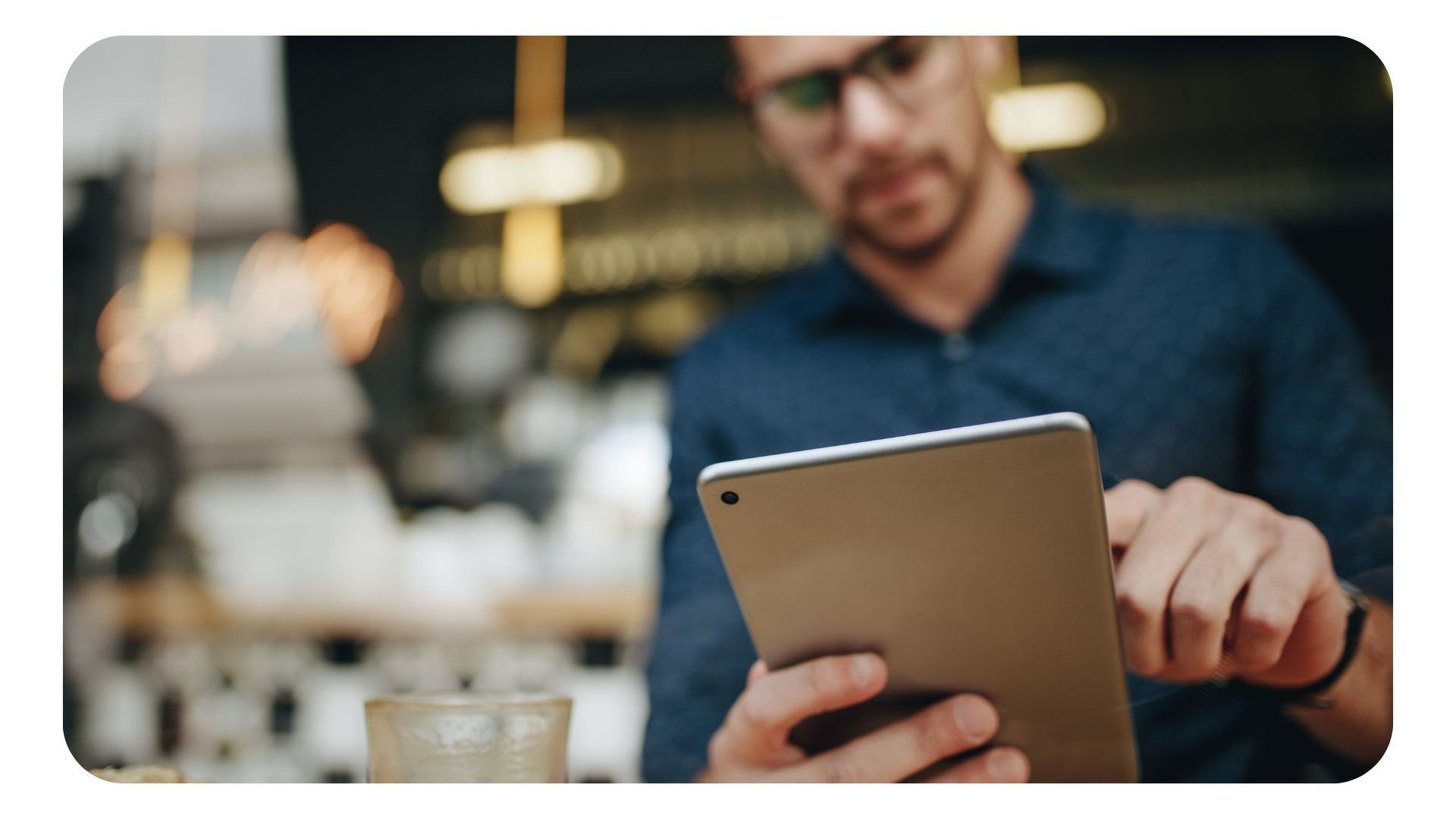 Male worker using tablet device in restaurant