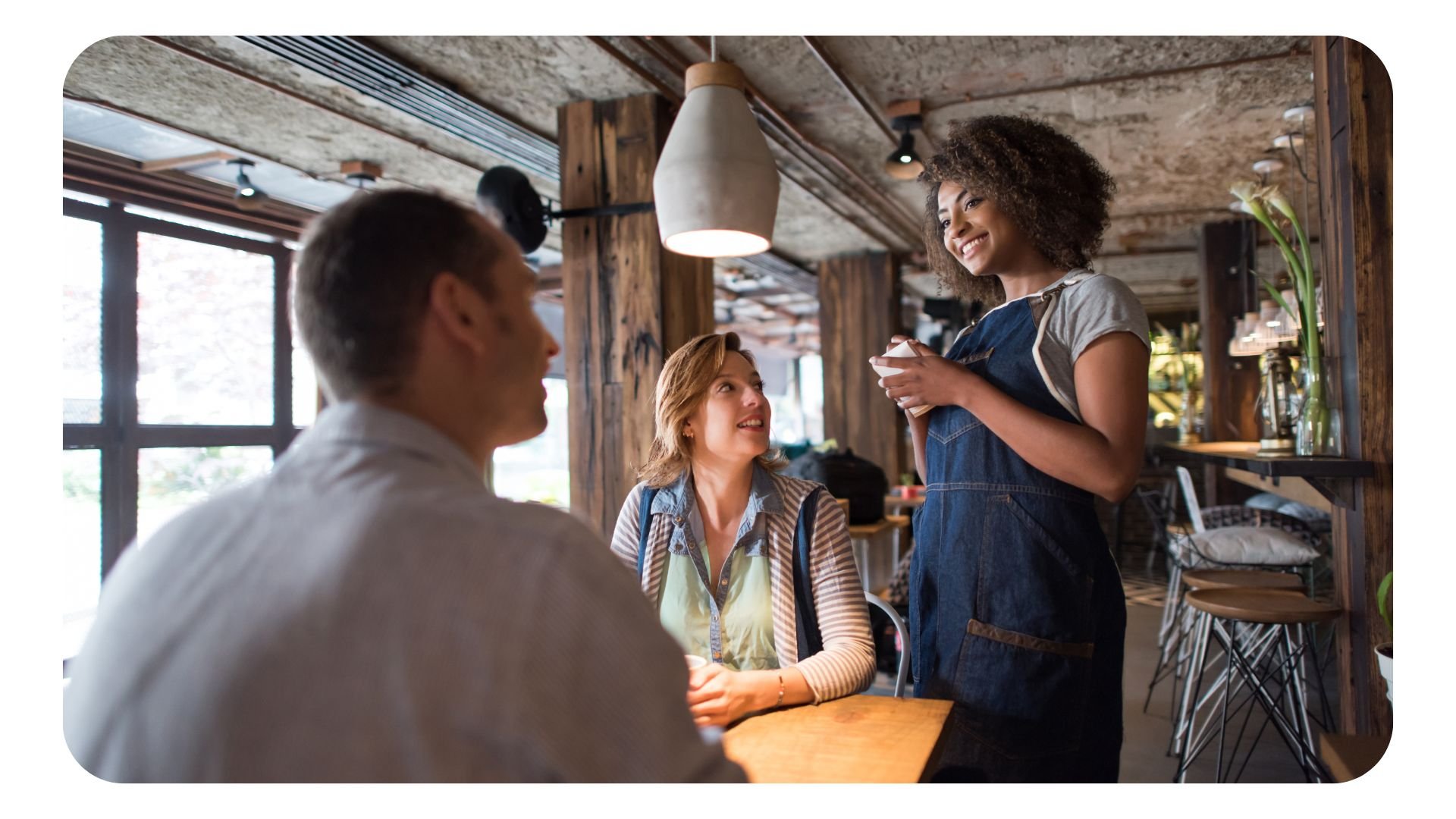 Waitress serving customers in restaurant