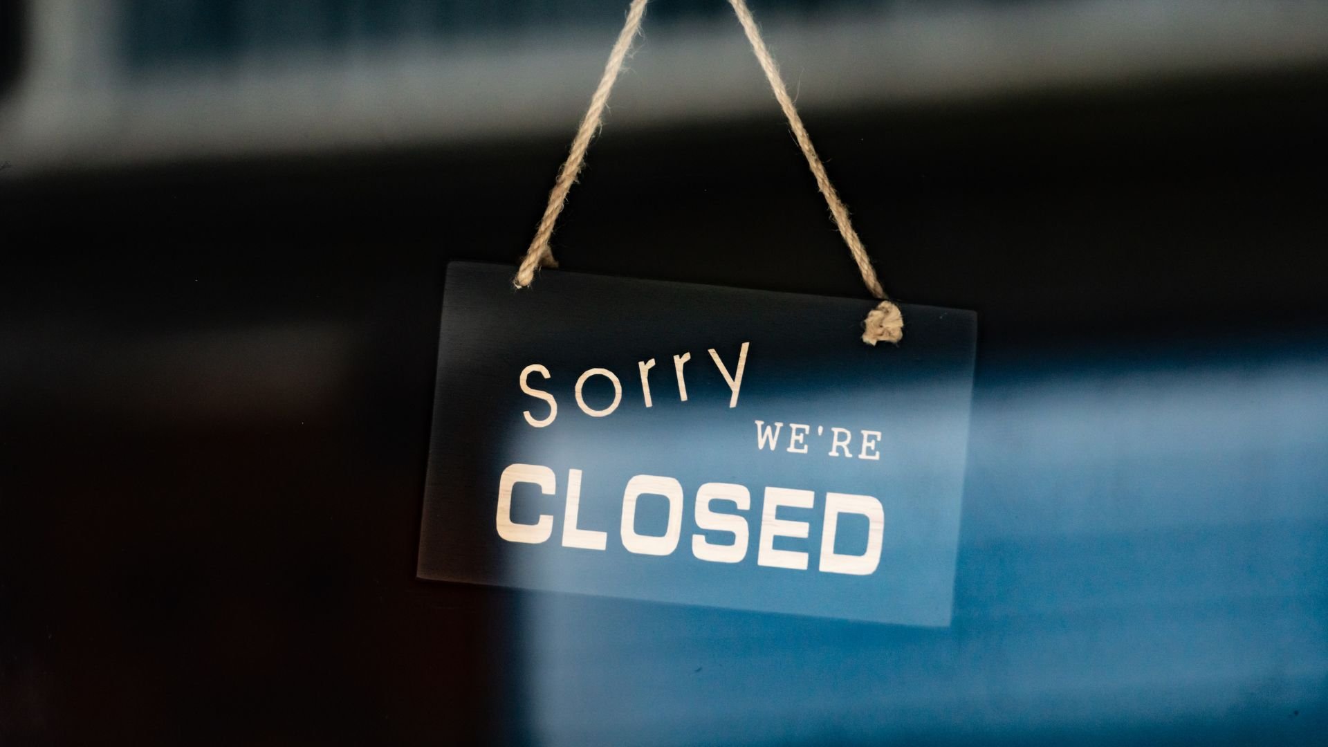 Photo of sign in restaurant door saying sorry we are closed