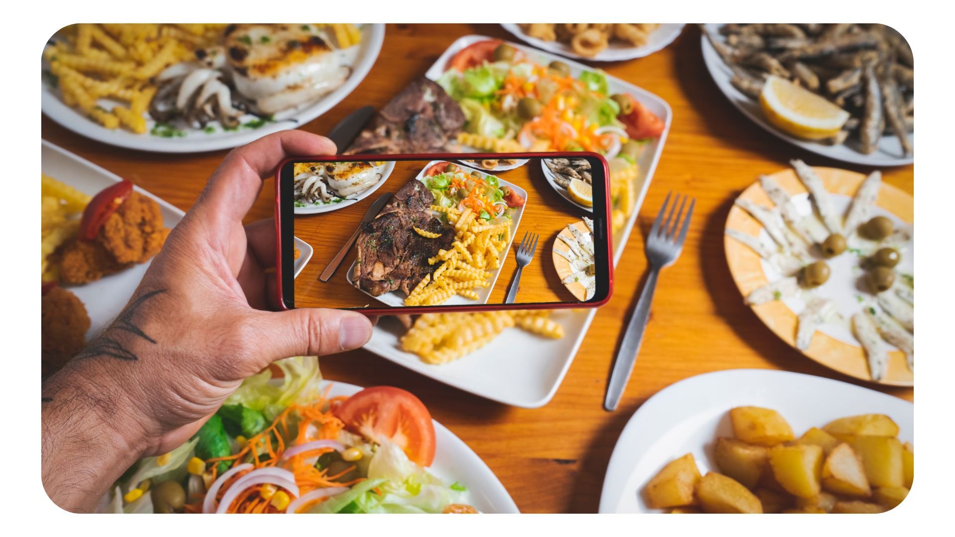 Photograph birdseye view of smartphone taking a picture of restaurant food for social media marketing