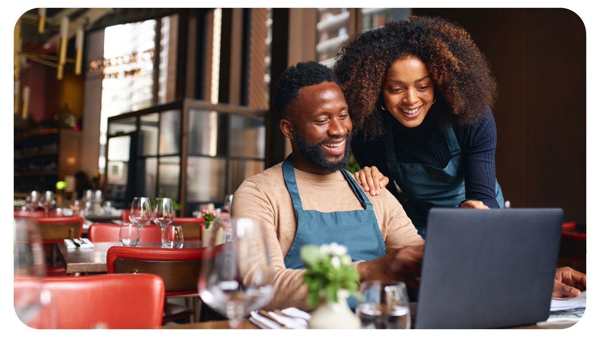 Photo of restaurant managers using laptop