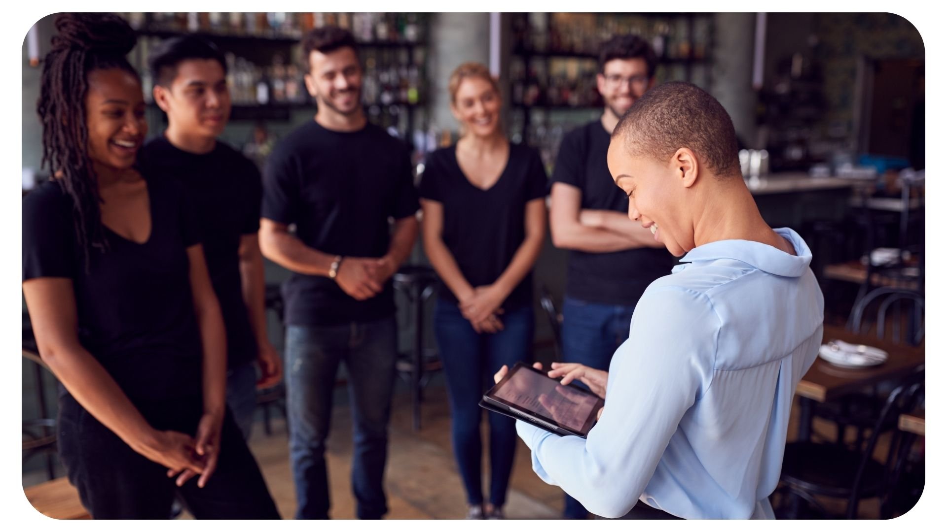 Photo of two restaurant workers using a tablet