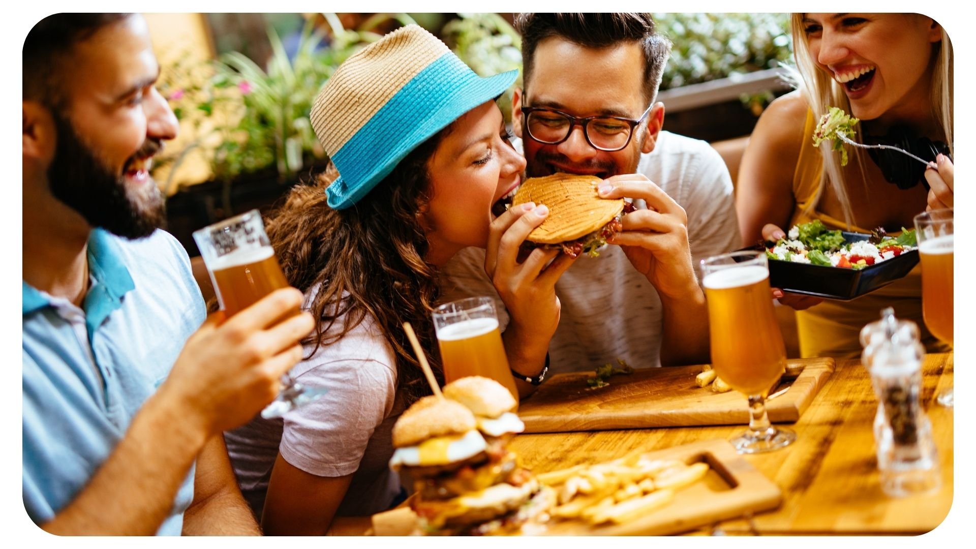 Photo of woman enjoying a bite of her meal at a trendy restaurant