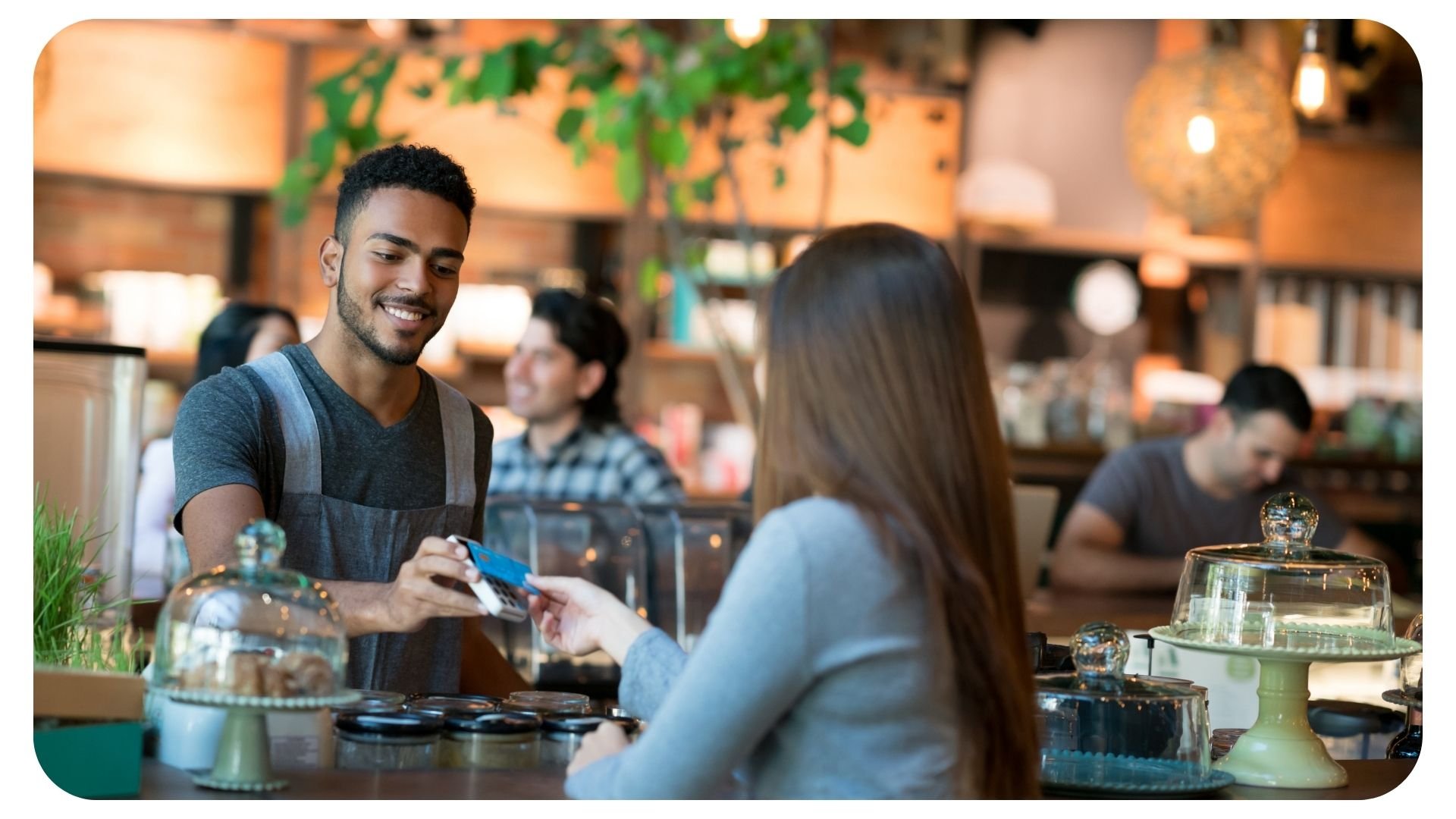 Photo of woman using her credit card to pay for food in a restaurant