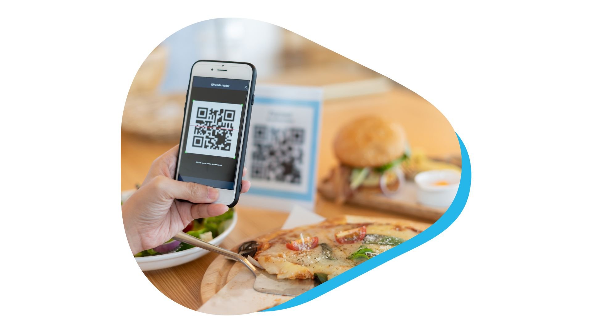 A hand waving a smartphone over QR code in restaurant