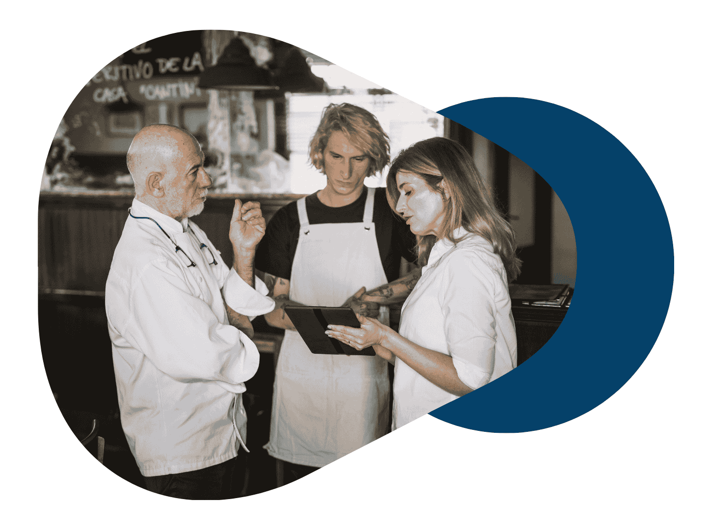 Restaurant manager, chef and waiter looking at a tablet in conversation